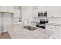 Modern kitchen features a granite island with stainless steel appliances and ample cabinet space at 261 Six Mile Creek Dr., Georgetown, SC 29440