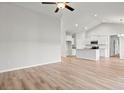 Open-concept living room and kitchen area features light wood flooring and high vaulted ceilings at 261 Six Mile Creek Dr., Georgetown, SC 29440