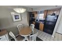 The kitchen features wood cabinets and black appliances, plus a dining table with white chairs at 2701 N Ocean Blvd. # 1561-64, Myrtle Beach, SC 29577