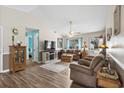 Comfortable living room with wood floors, a ceiling fan, and a view toward the home's entrance at 2759 Temperance Dr., Myrtle Beach, SC 29577
