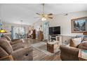 Bright living room featuring wood floors, large TV, ceiling fan, and an adjacent dining area at 2759 Temperance Dr., Myrtle Beach, SC 29577