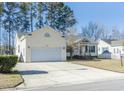 Bright home featuring an attached garage and large driveway at 323 Stone Throw Dr., Murrells Inlet, SC 29576