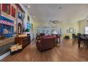 Open-concept living room featuring hardwood floors, a ceiling fan, and a unique mural at 3901 Bay Pines Ct., North Myrtle Beach, SC 29582
