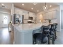 Modern kitchen with a large island, stainless steel appliances, and white cabinets at 404 Cattle Drive Circle, Myrtle Beach, SC 29588
