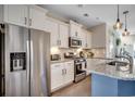 Modern kitchen with stainless steel appliances, white cabinetry, and granite countertops at 4123 Mclamb Ave. # 4123, Little River, SC 29566