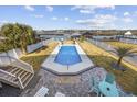 Backyard pool with views of the water, featuring a patio area and manicured landscaping at 414 S Dogwood Dr., Garden City Beach, SC 29576