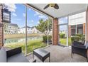 Relaxing screened-in porch with views of the picturesque pond and backyard at 4142 Hibiscus Dr. # 104, Little River, SC 29566