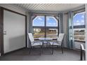 Enclosed outdoor patio with two chairs, a table, and beautiful views of the marsh at 501 Maison Dr. # F-1, Myrtle Beach, SC 29572