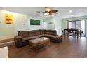 Comfortable living room with wood floors, ceiling fan, and sliding door to patio at 508-B Rosemary Ln., North Myrtle Beach, SC 29582