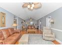 Cozy living room featuring hardwood floors, neutral paint, ceiling fan, and comfortable seating at 511 N 21St Ave. N, North Myrtle Beach, SC 29582