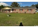 A beautiful lawn surrounds this single story brick home with well manicured landscaping at 538 Oatland Rd., Georgetown, SC 29440