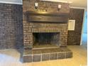 Living room featuring a large brick fireplace with decorative mantle and tile hearth at 538 Oatland Rd., Georgetown, SC 29440