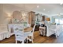 Cozy dining area next to kitchen with an decorative chandelier, wood floors, and plenty of light at 622 Lorenzo Dr. # 622, North Myrtle Beach, SC 29582
