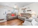 Inviting living room with hardwood floors, neutral paint, and comfortable seating at 701 1St Ave. S # 32C, North Myrtle Beach, SC 29582