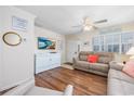 Cozy living room featuring wood-look flooring, a ceiling fan, and coastal decor at 701 1St Ave. S # 32C, North Myrtle Beach, SC 29582