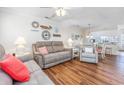 Inviting living room featuring luxury vinyl flooring, a ceiling fan, and stylish coastal decor at 701 1St Ave. S # 32C, North Myrtle Beach, SC 29582