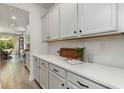 Bright kitchen featuring white cabinetry, a spacious quartz countertop, and modern appliances at 918 Belle Dr., North Myrtle Beach, SC 29582
