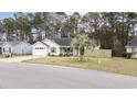 Charming single story home with manicured lawn, attached garage and covered front porch at 945 Castlewood Dr., Conway, SC 29526
