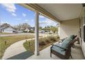 Cozy covered front porch featuring seating and a view of the landscaped front yard at 945 Castlewood Dr., Conway, SC 29526