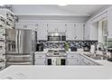 Well-lit kitchen featuring stainless steel appliances, gray cabinets, and stylish backsplash at 945 Castlewood Dr., Conway, SC 29526