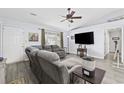 Comfortable living room with vaulted ceiling, ceiling fan and hardwood floors at 945 Castlewood Dr., Conway, SC 29526