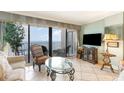 Cozy living room with large windows showcasing ocean views and comfortable seating area at 10200 Beach Club Dr. # 6B, Myrtle Beach, SC 29572