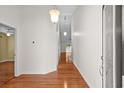 Bright hallway featuring hardwood floors, elegant lighting, and neutral wall paint at 1205 Woodruff Ct., Conway, SC 29526