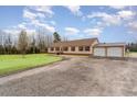 Well-maintained single-story house with a long driveway and detached two-car garage, offering ample parking at 1888 Singing Pines Dr., Conway, SC 29527