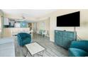 Comfortable living area featuring modern decor, a flat-screen TV, and a partial kitchen view at 2000 N Ocean Blvd. # 1601, Myrtle Beach, SC 29577