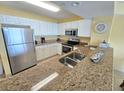 Bright, well-equipped kitchen featuring granite countertops, stainless appliances, and ample cabinet space at 2007 S Ocean Blvd. # 204, Myrtle Beach, SC 29577
