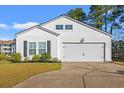 Charming single-Gathering home boasts a bright white exterior, a two-car garage, and professional landscaping at 2015 Borgata Loop, Longs, SC 29568