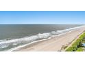 Wide aerial view capturing the expansive beach and ocean, under a bright, clear sky at 2201 S Ocean Blvd. # 1806, Myrtle Beach, SC 29577