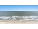 Beautiful beach aerial showcasing ocean waves meeting the sandy shore, under a clear blue sky at 2201 S Ocean Blvd. # 1806, Myrtle Beach, SC 29577