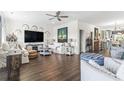 Open-concept living room boasts hardwood floors, stylish decor, and a comfortable seating arrangement at 2304 Pointe Marsh Ln., North Myrtle Beach, SC 29582