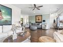Bright living room featuring hardwood floors, high ceilings, stylish furniture, and ample natural light at 2304 Pointe Marsh Ln., North Myrtle Beach, SC 29582