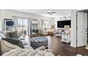 Spacious living room with hardwood floors, large windows, comfortable seating, and stylish decor at 2304 Pointe Marsh Ln., North Myrtle Beach, SC 29582