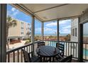 Balcony view overlooking pool and ocean, with outdoor seating and a partial view of other condo buildings at 2405 S Ocean Blvd. # 105, North Myrtle Beach, SC 29582