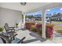 Inviting covered porch with rocking chairs and views of the quiet residential street at 248 Upper Saddle Circle, Conway, SC 29526