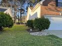 A lush green side yard features small trees and decorative rocks at 280 Barclay Dr., Myrtle Beach, SC 29579