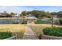 Picturesque backyard featuring a covered dock and direct access to the waterfront at 288 Rum Gully Rd., Murrells Inlet, SC 29576