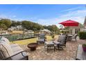 Inviting outdoor patio with comfortable seating, a fire pit, and scenic water views at 288 Rum Gully Rd., Murrells Inlet, SC 29576