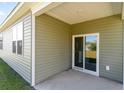 Cozy covered patio with a sliding glass door leading to the backyard at 303 Clear Lake Dr., Conway, SC 29526