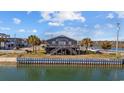 Charming coastal home with a private dock and stunning waterfront views at 310 37Th Ave. N, North Myrtle Beach, SC 29582