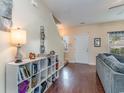 Bright and airy living room with hardwood floors, shelving, and a view of the staircase at 3129 Bramble Glen Dr., Myrtle Beach, SC 29579
