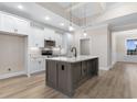 Bright kitchen features white cabinets, stainless steel appliances, and a large island at 3329 Hughes Gasque Rd., Aynor, SC 29511