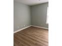 Empty bedroom with wood-look floors, neutral paint, and bright window at 4390 Daphne Ln. # D, Murrells Inlet, SC 29576