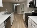 Modern kitchen with stainless steel appliances, white cabinets, and light countertops at 4390 Daphne Ln. # D, Murrells Inlet, SC 29576