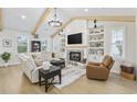Spacious living room with fireplace, custom built-ins, vaulted ceilings, and natural light at 5368 Ocean Village Dr., Myrtle Beach, SC 29577