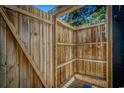 Rustic outdoor shower featuring wood enclosure, shower head, and built-in shelving at 6001 - 1527 S Kings Hwy., Myrtle Beach, SC 29575