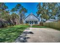 Beautiful home boasts a spacious lawn, inviting porch with rocking chairs, and charming curb appeal at 624 Blackberry Ave., Murrells Inlet, SC 29576